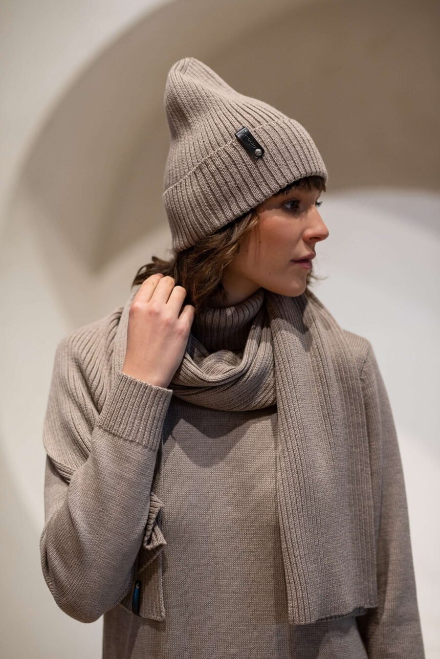 A set of a light beige hat and a scarf.