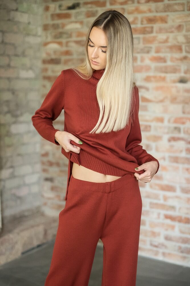 Red Merino wool turtleneck sweater paired with straight-leg pants