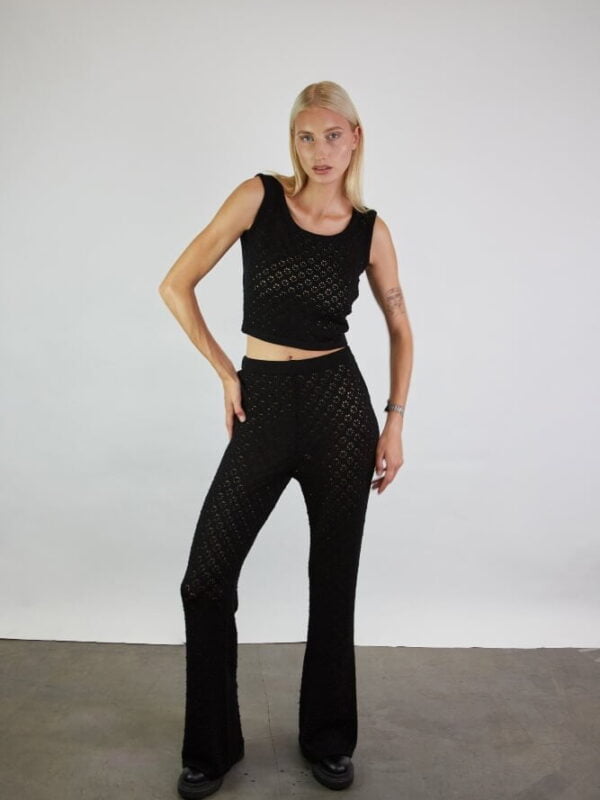 A set of a knitted crop top in lace and matching wide-leg trousers