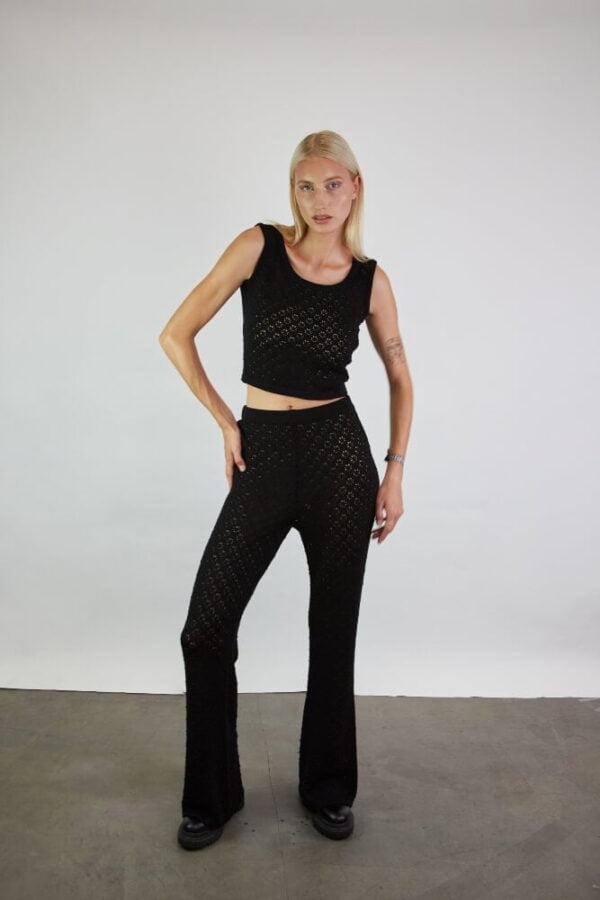 A set of a knitted crop top in lace and matching wide-leg trousers