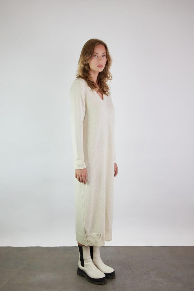 A long merino wool dress with long sleeves and a V-neck
