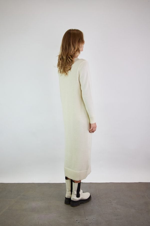 Handmade merino wool dress with a long ribbed hem and a V-neckline in natural white