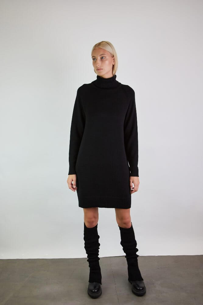 Minimalist wardrobe basic in black merino styles with knee-length leg warmers layered over matching boots