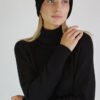 A black set of a headband and a raglan sleeve dress with a roll neck