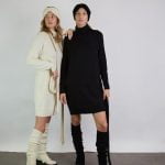 Two girls wearing one-color outfits. One is wearing natural white merino wool clothing, the other - black.