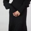 A feminine merino wool dress with subtle puff sleeves and ribbed cuffs