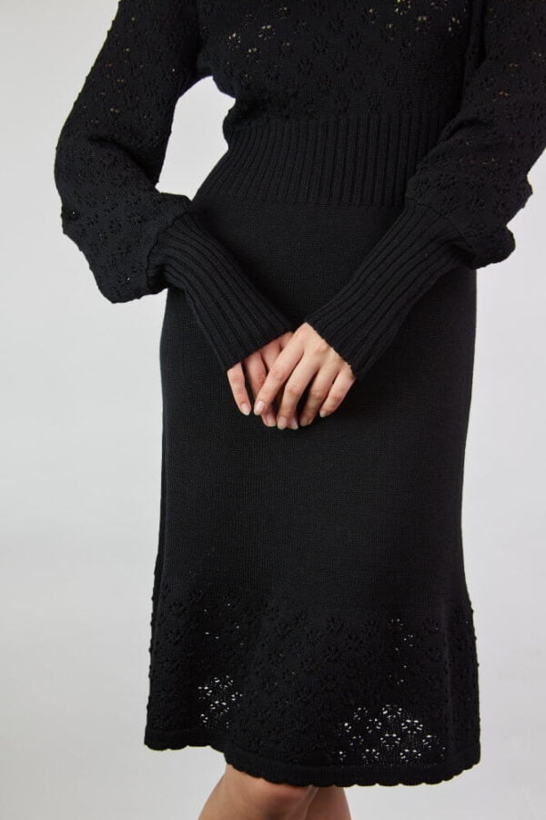 A feminine merino wool dress with subtle puff sleeves and ribbed cuffs