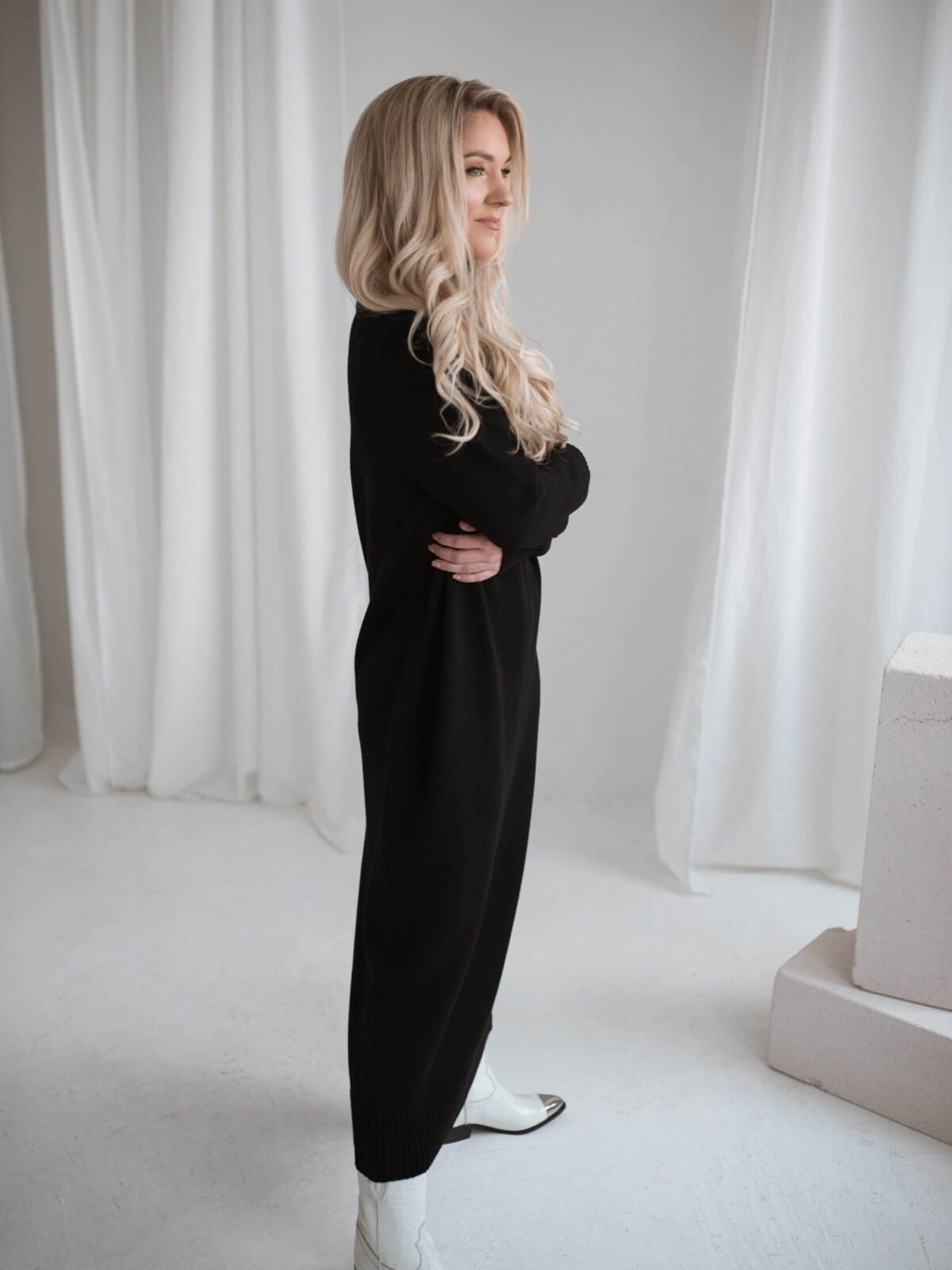 Handmade merino wool dress in a minimalist cut. With a roll neck and long loose-fitting sleeves.