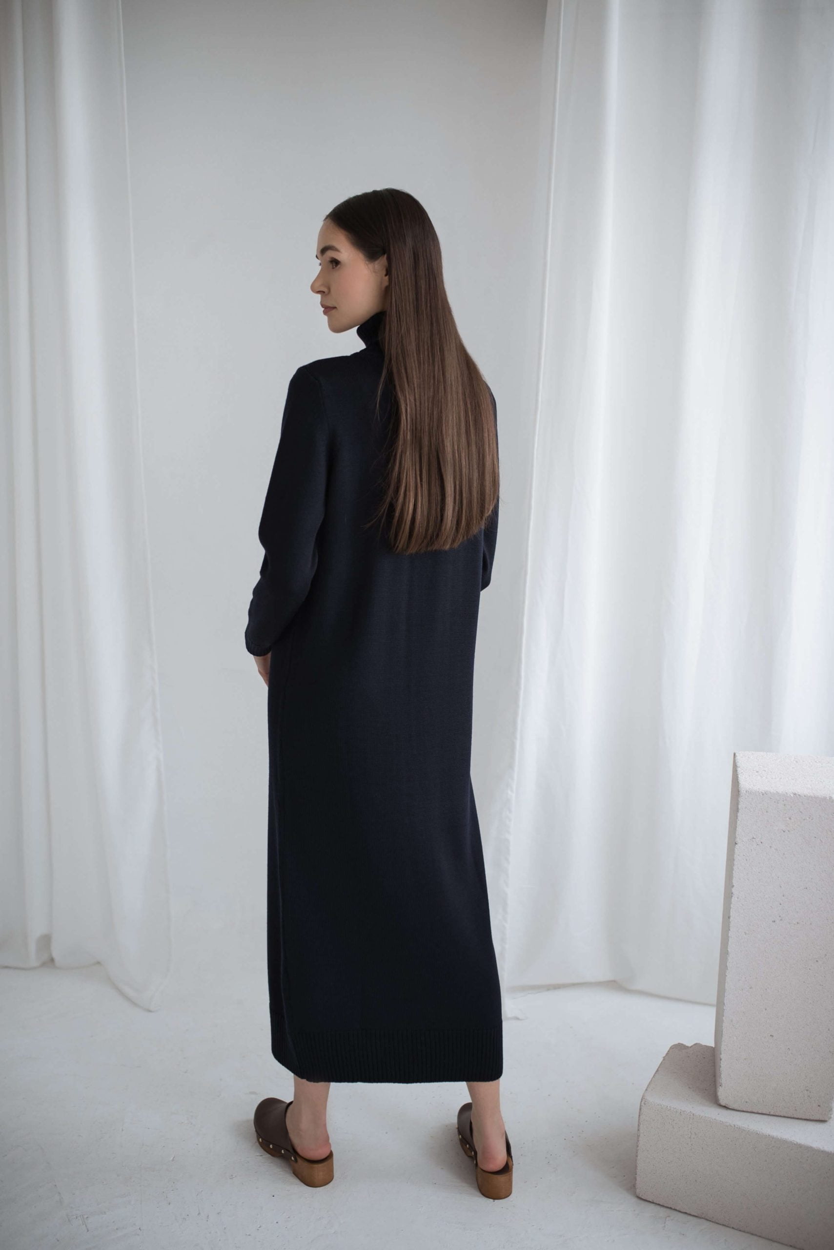 Oversized merino wool dress in black. Roll neck and ribbed cuffs.