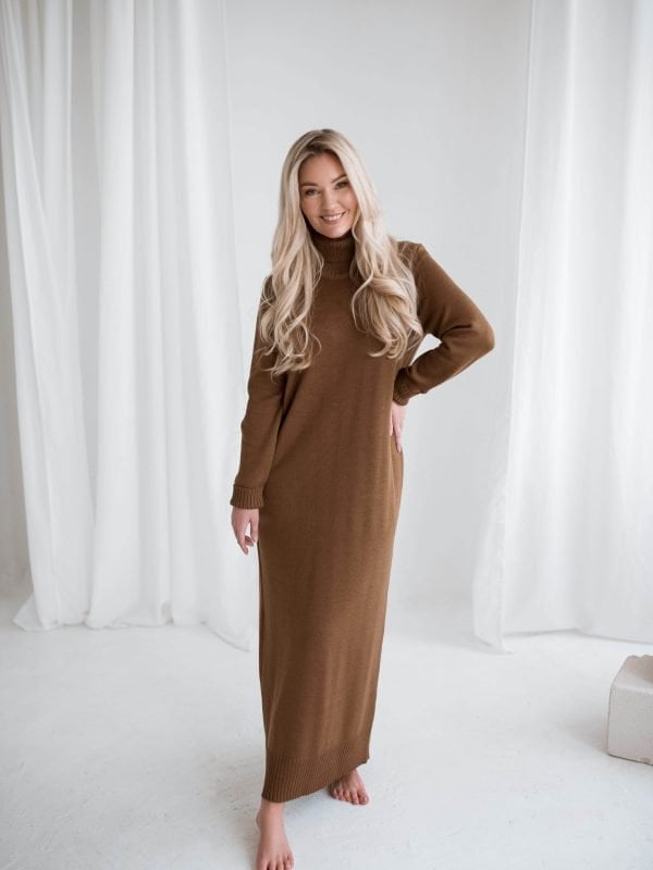 A knit sweater dress with a roll neck and long sleeves. Oversized pencil silhouette.