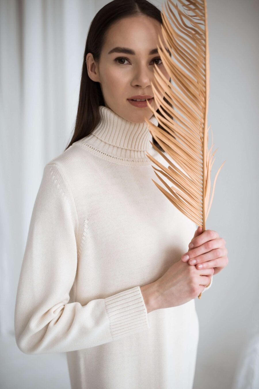 A knitted merino wool dress with set-in sleeves and a roll neck. Handmade in Lithuania