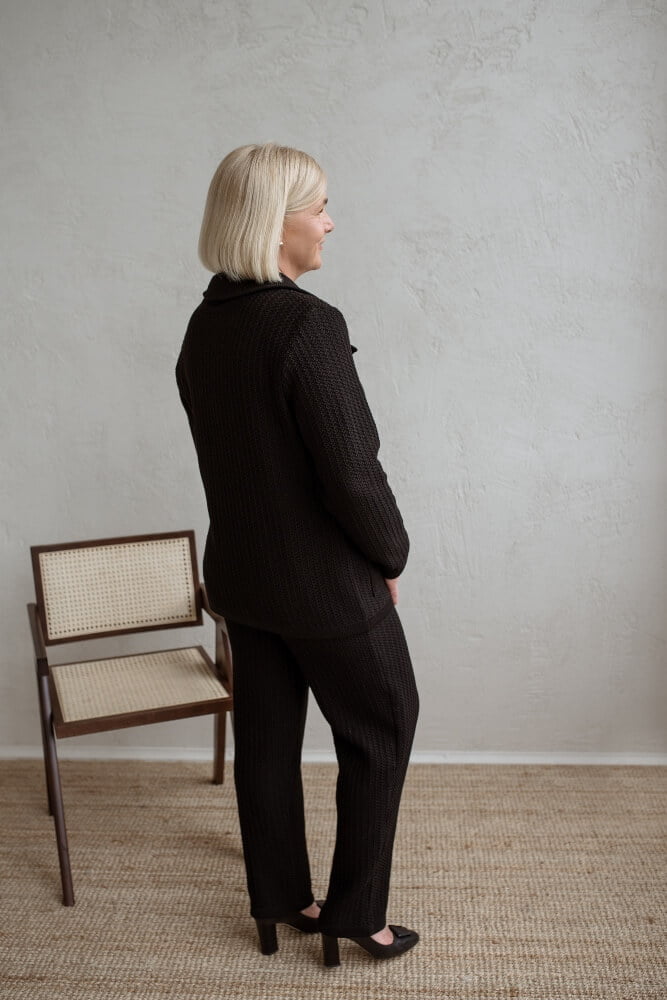 A lady in a matching set of a merino wool sweater and tapered-leg pants
