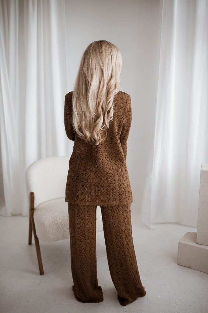 A merino wool set of a top and wide-leg pants. Knitted in a lace pattern.