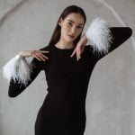 Black merino wool dress with white feather cuffs