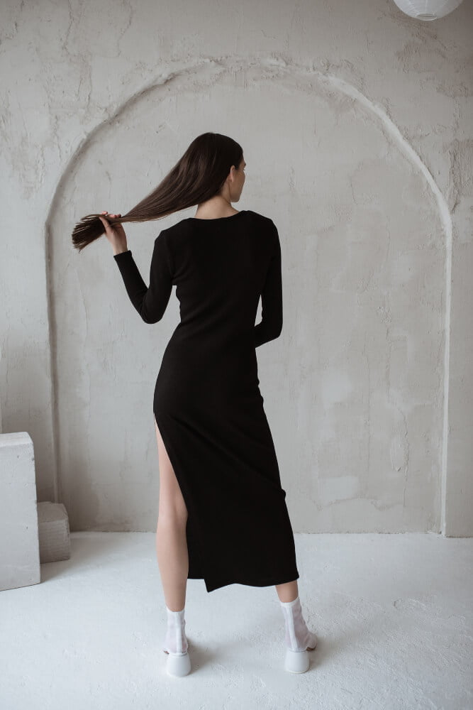 Black dress with long sleeves, a crew neck, and a side slit