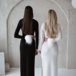 Two girls wearing black and white dress in merino wool