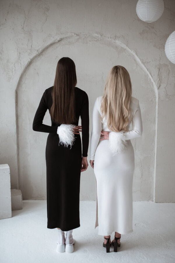Two girls wearing black and white dress in merino wool