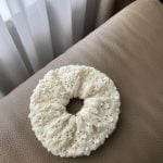 Knitted hair scrunchie with a subtle eyelet pattern. Natural white color, merino wool