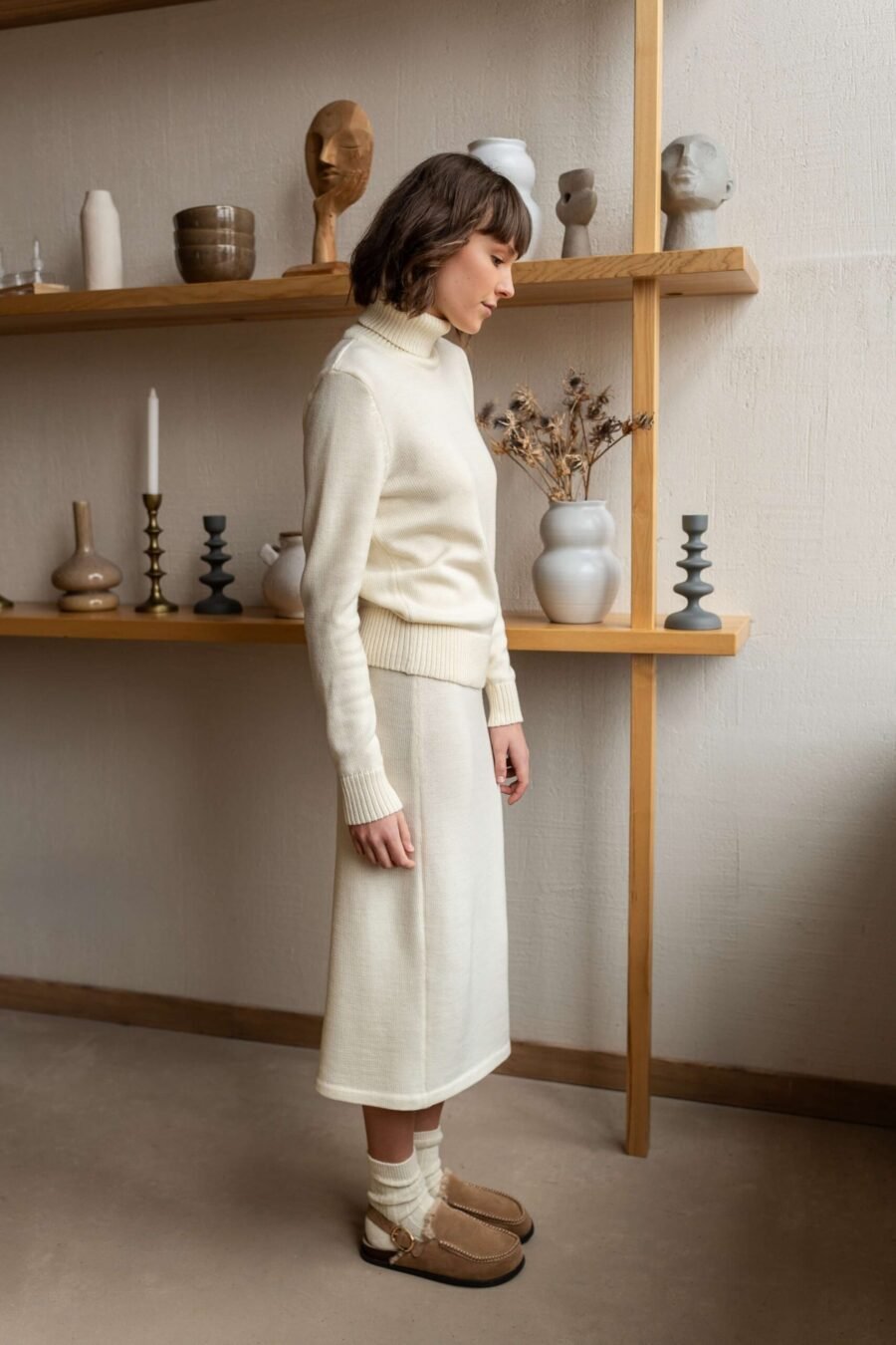 Two-piece set of a natural white turtleneck sweater and a matching skirt featuring an elastic waistband.