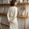 Two-piece set of a natural white turtleneck sweater and a matching skirt featuring an elastic waistband.