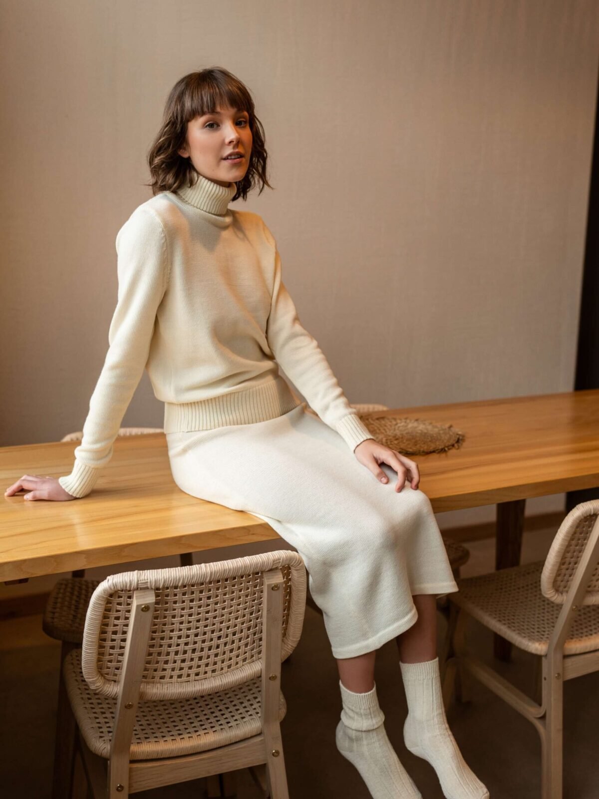 A set of a turtleneck sweater and a matching pencil skirt. Made of extra fine merino wool.