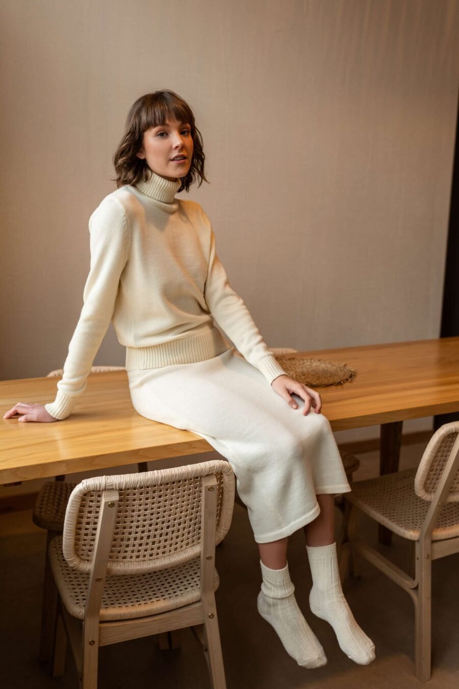 A set of a turtleneck sweater and a matching pencil skirt. Made of extra fine merino wool.