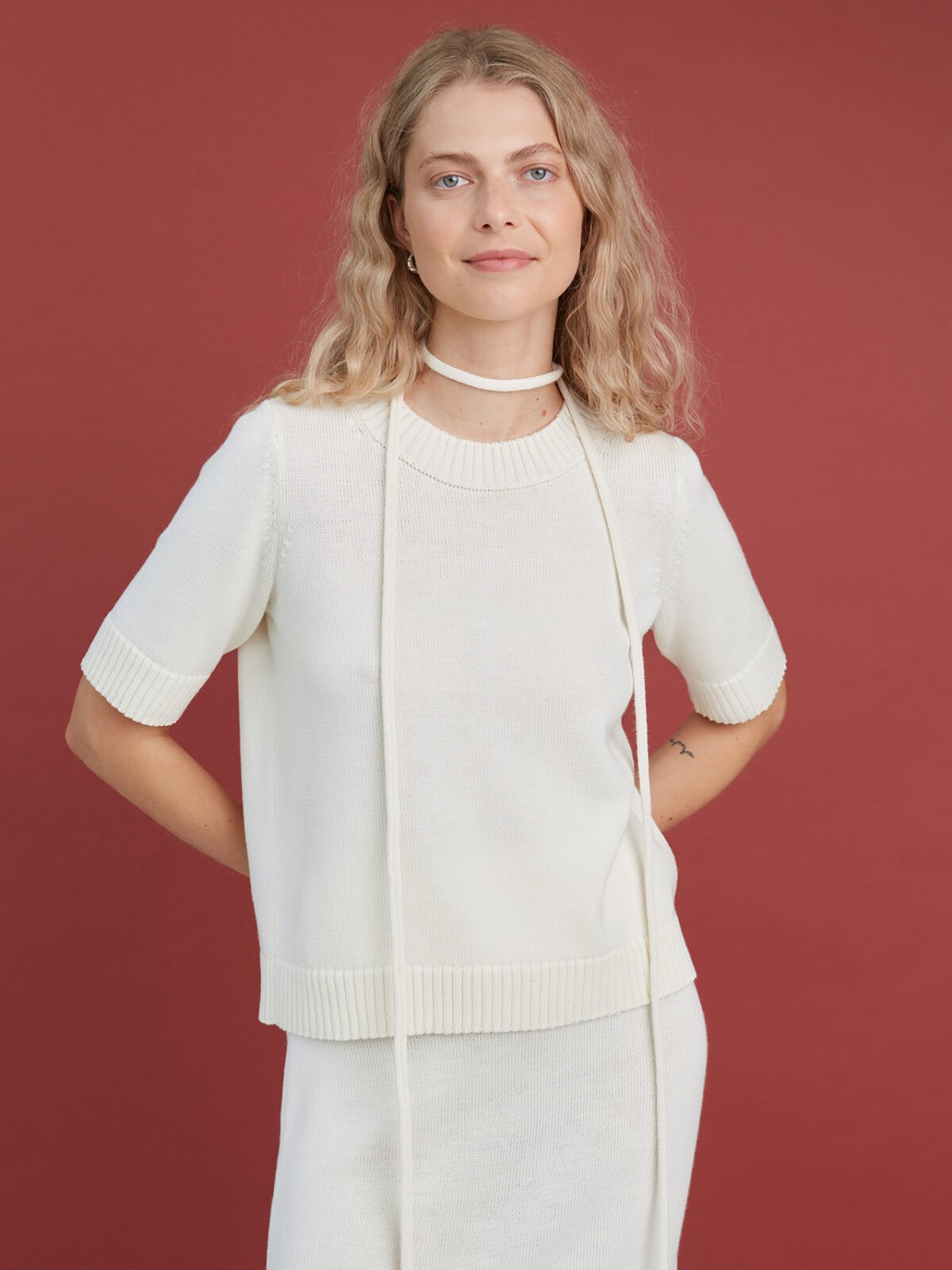 Knitted merino wool short sleeve sweater in natural white